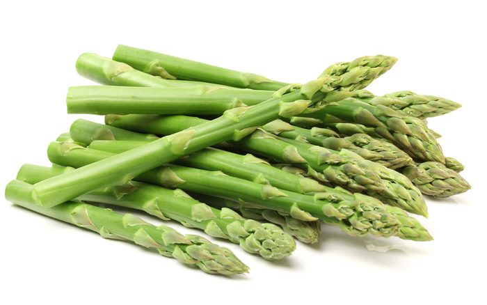 Fresh green asparagus on white