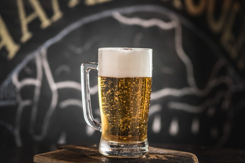 mug full of chopp, with chopp pilsen on a rustic table