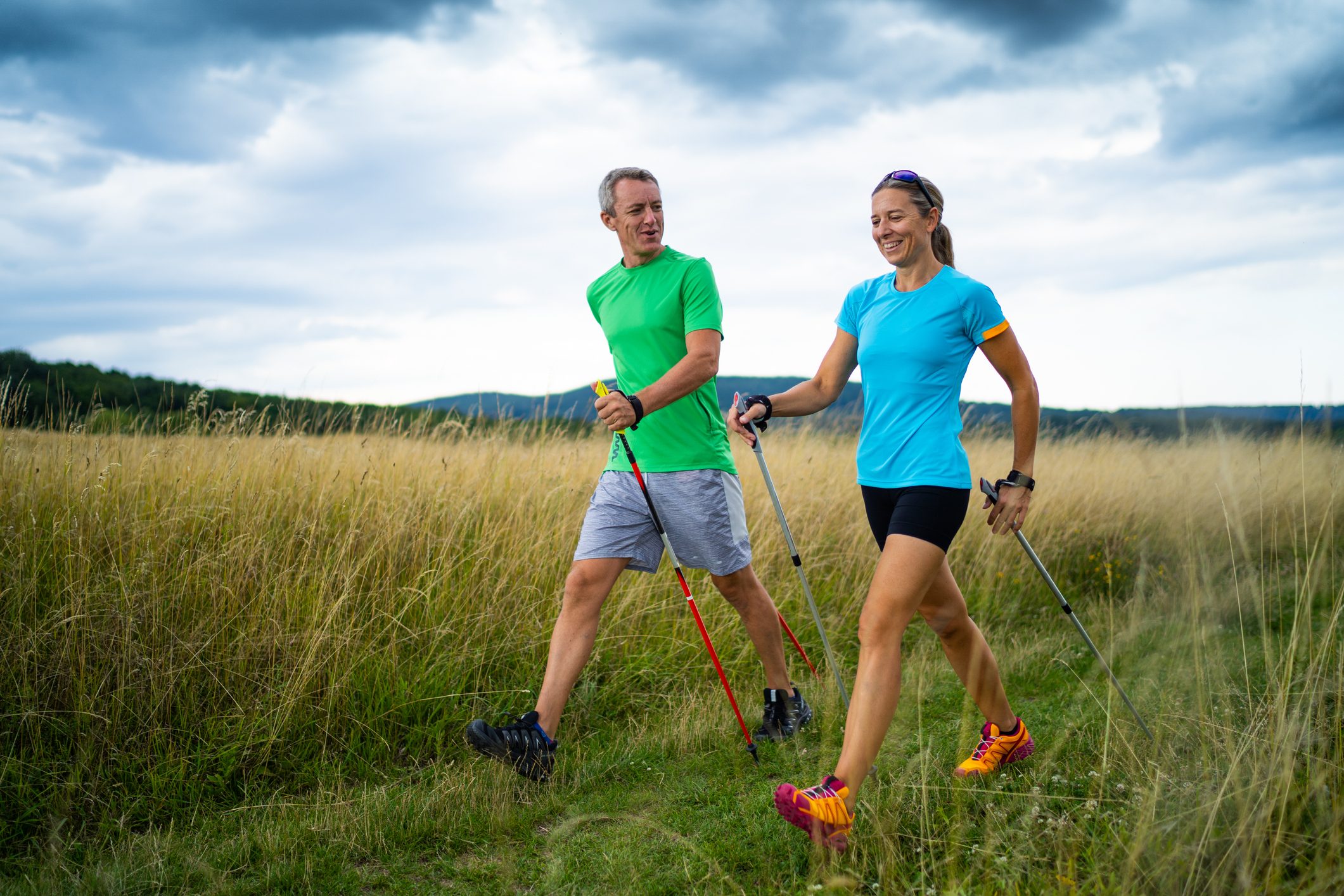 man and woman nordic walking