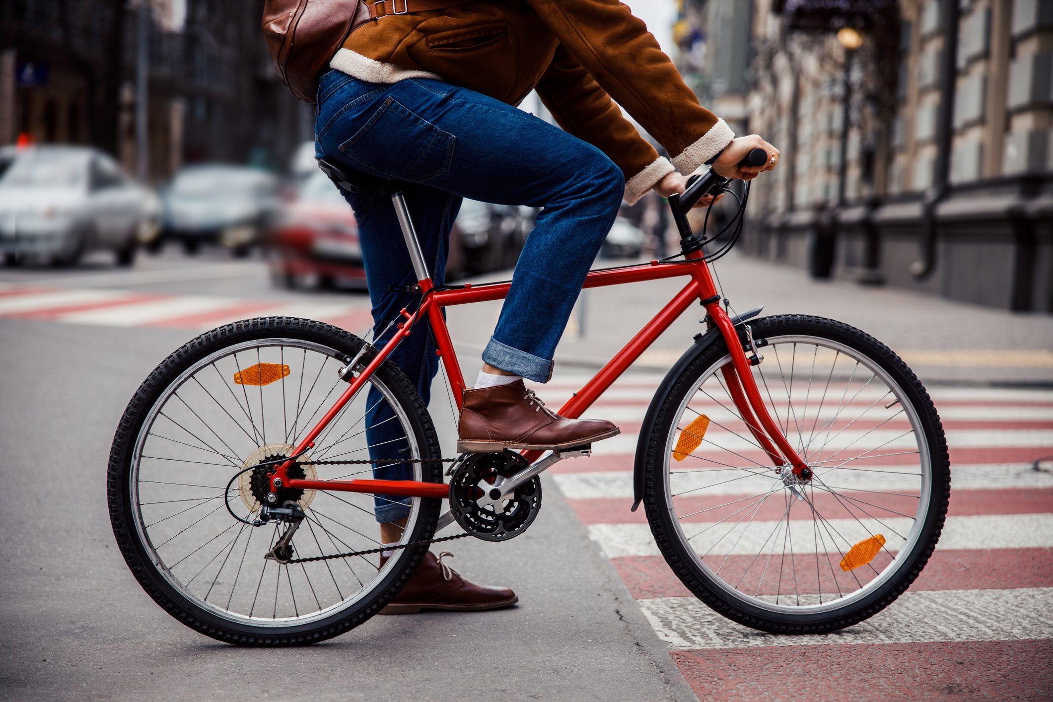 cropped shot of lower half of bike and man's legs