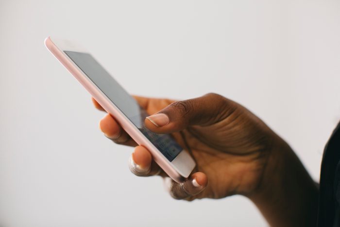 close up of woman holding smartphone
