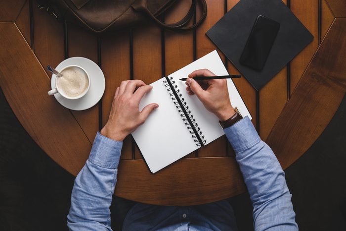 Man writing in notebook