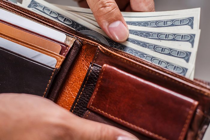 wallet with hundred dollar bills fanned out