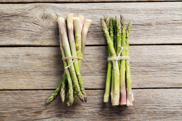 Fresh green asparagus on a grey wooden table