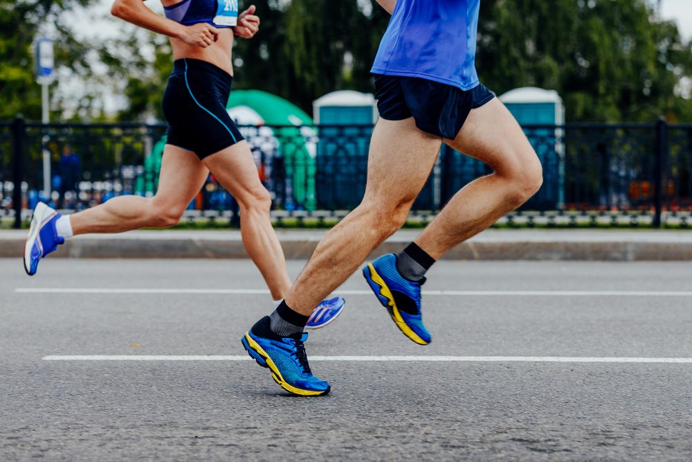 male and female runners running urban race together