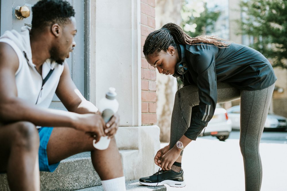 Athletic girl tying her shoelaces