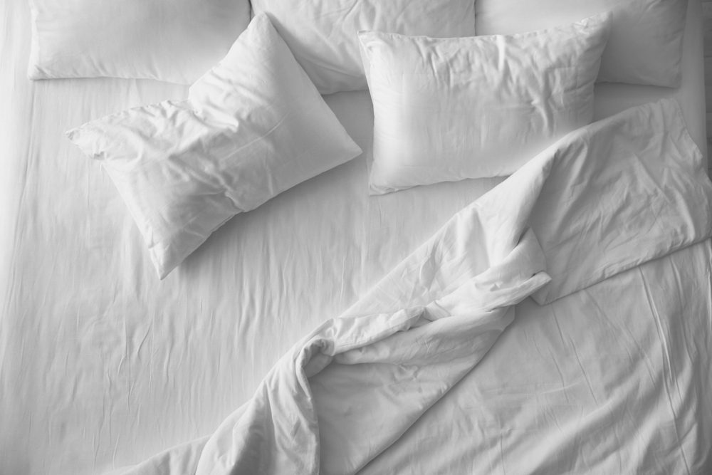 Soft pillows on comfortable bed, top view