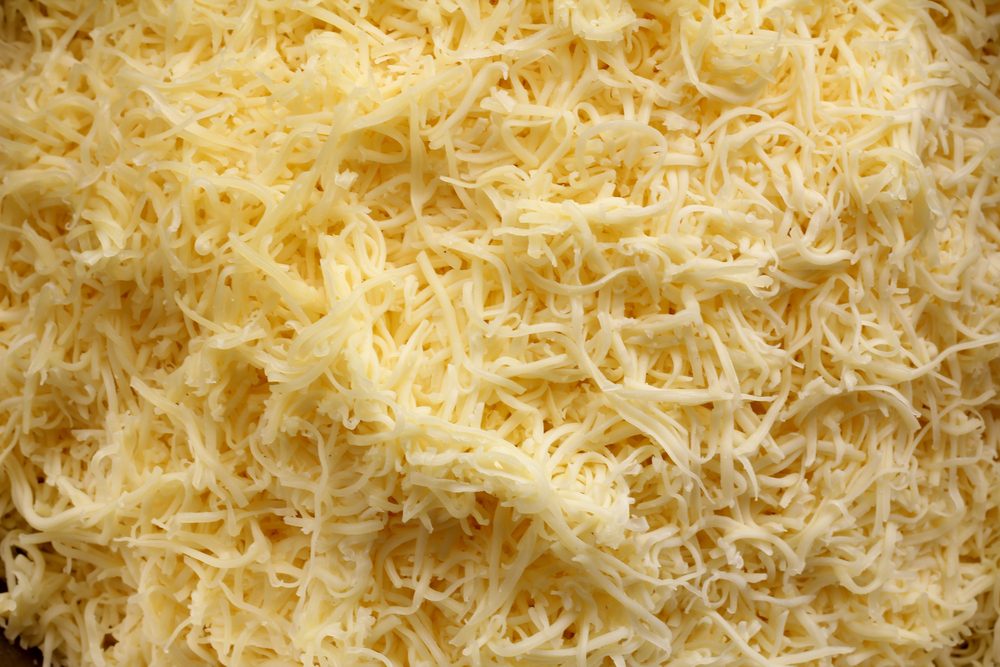 A close up image grated cheddar cheese