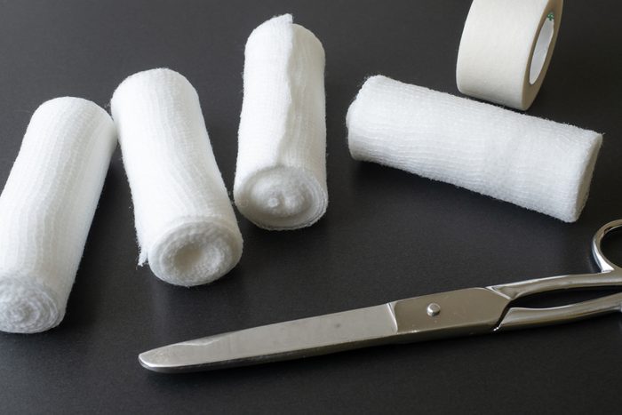 Rolls of gauze, medical tape, and scissors
