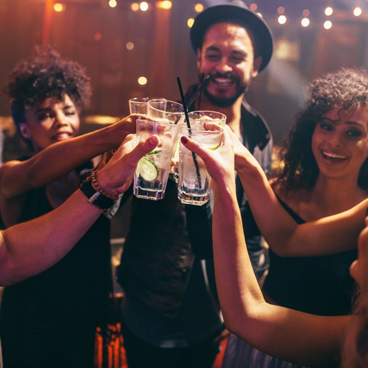 Group of friends having drinks at the night club party.