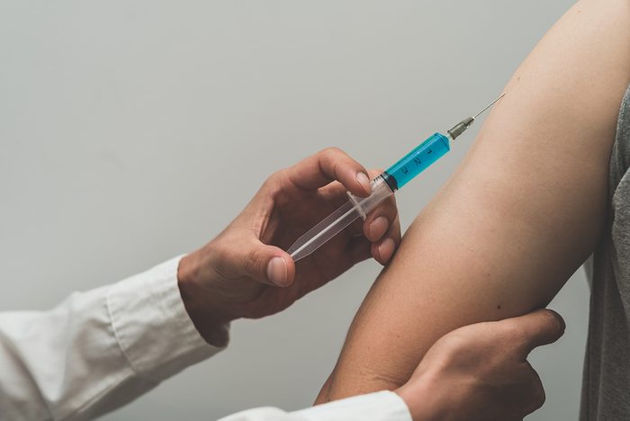 Doctor giving vaccine vial dose shot drug using the syringe,treated by the use of sterile injectable upper arm,injection,antibody,influenza vaccine medical, concept vaccination