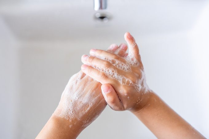 Hygiene concept. Kid washing hands with soap.