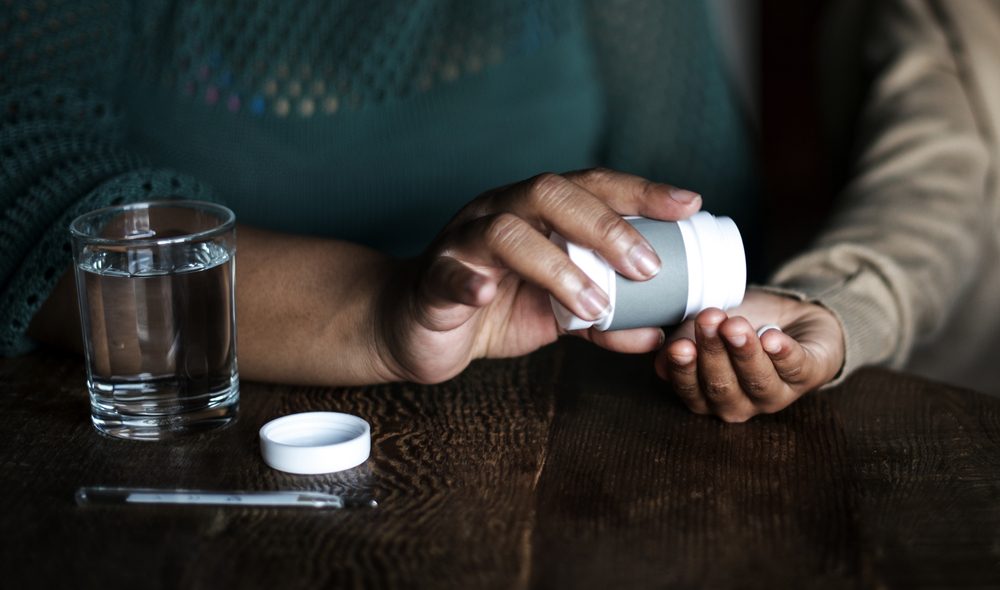 African woman taking her medicine