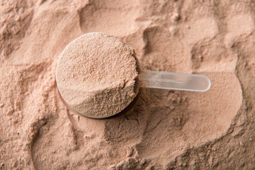 A scoop of chocolate whey isolate protein