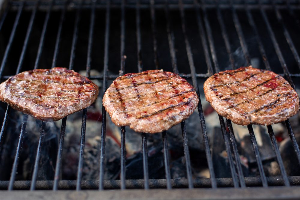 Grilled hamburger cutlets. Summer picnic with friends.