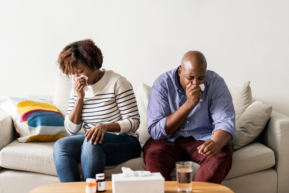 Couple sick at home on the sofa