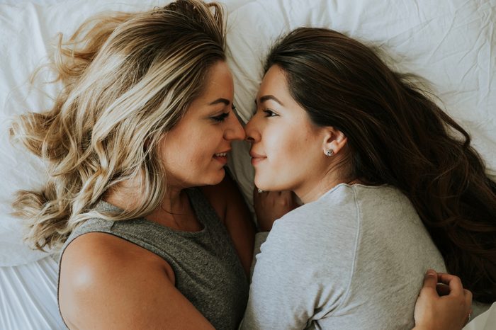 Lesbian couple together in bed