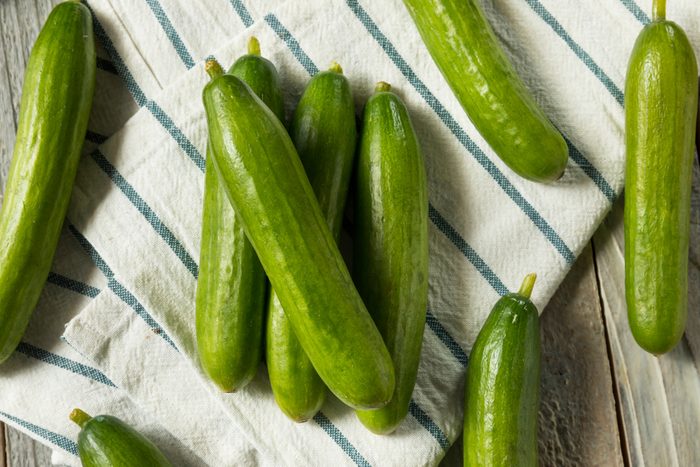 Raw Green Organic Persian Cucumbers in a Pile