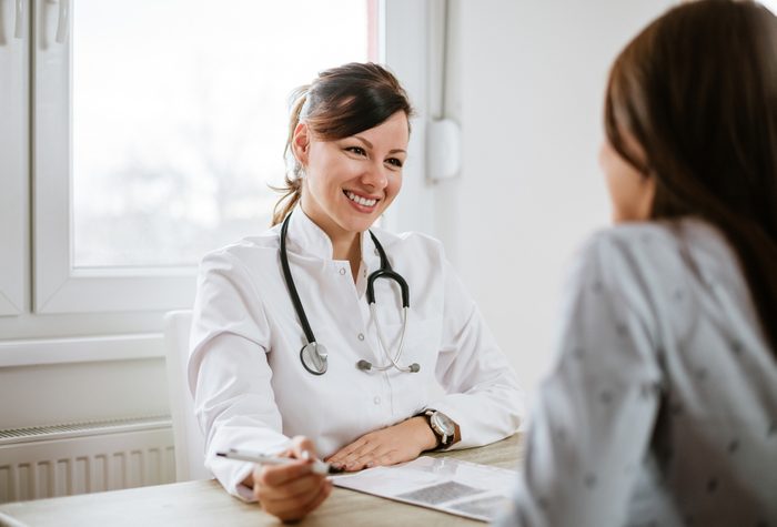 Smiling young doctor having a medical exam.
