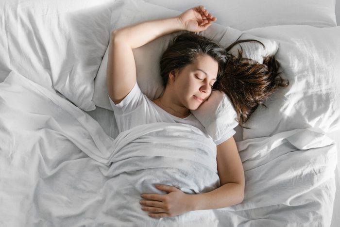 woman sleep in bed sunshine thought the window