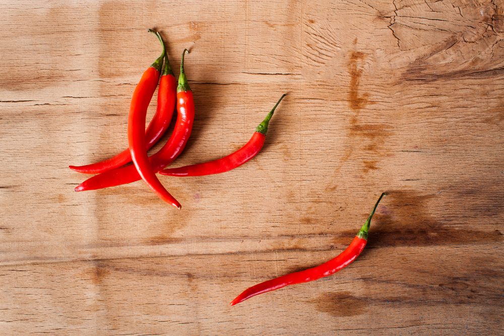 Chili peppers on a wooden cutting board