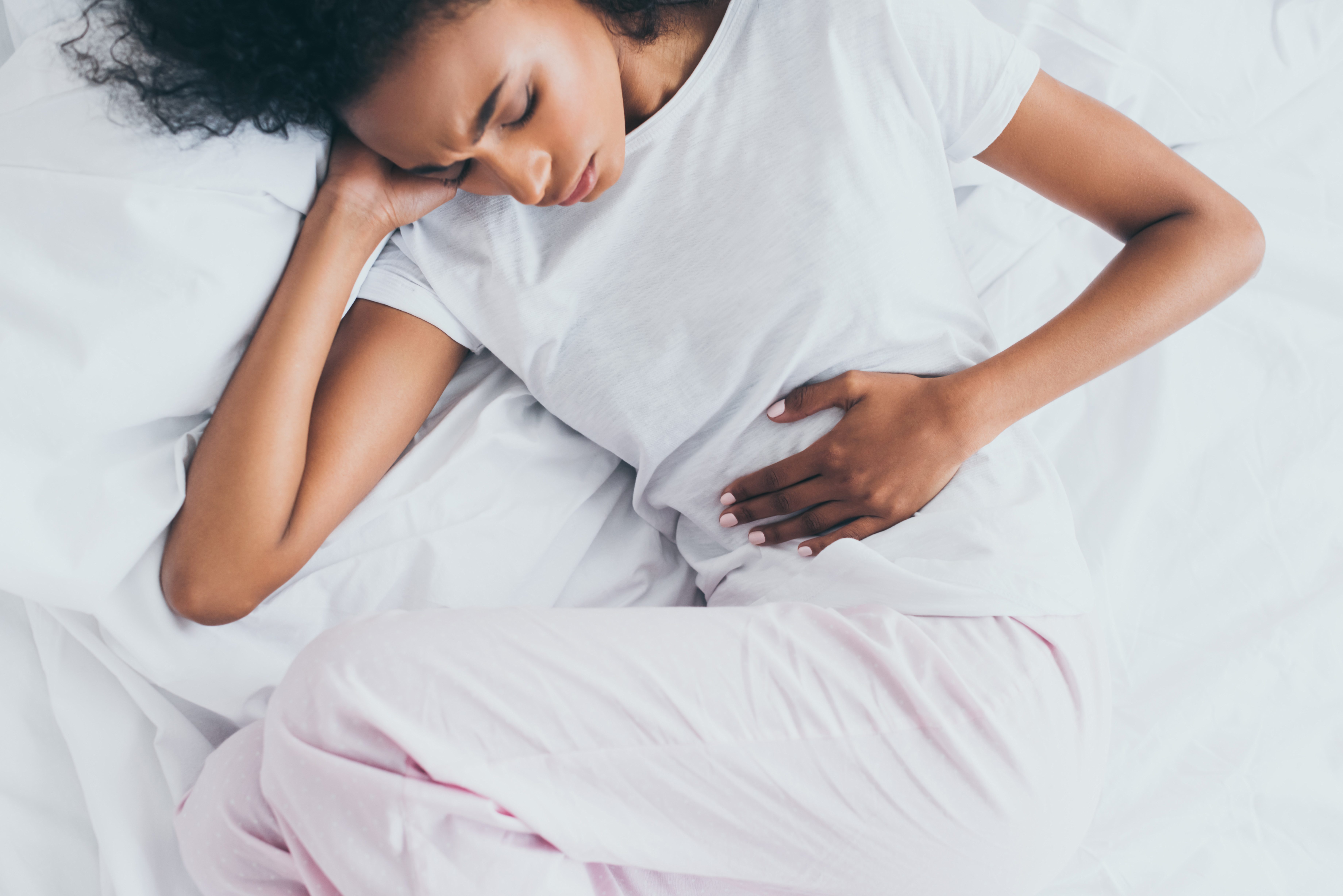 woman over head feeling nausea stomach pain