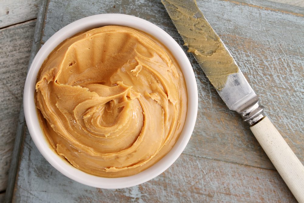 peanut butter in bowl with knife