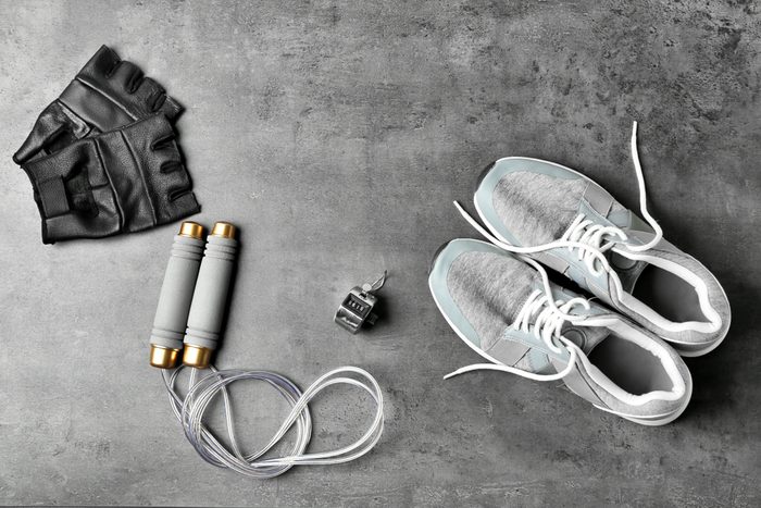 Composition with jumping rope on grey background