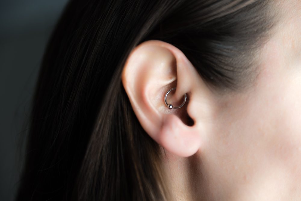 medicinal earring in ear to treat headaches