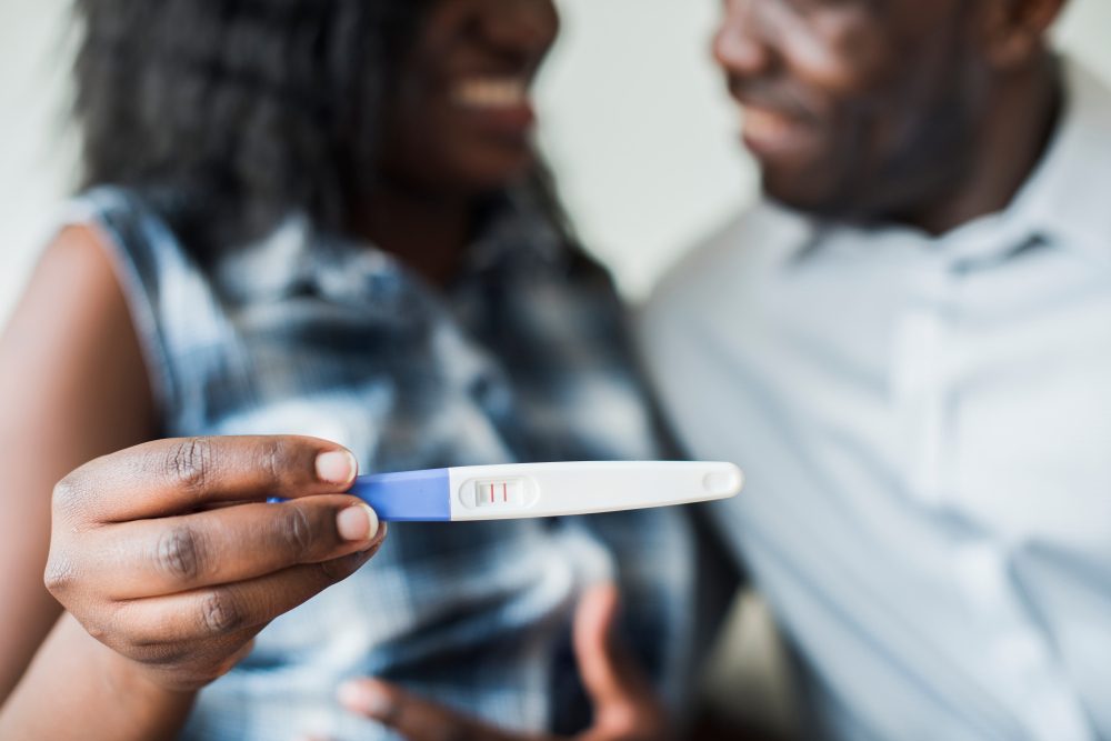 Black couple with a positive pregnancy test result