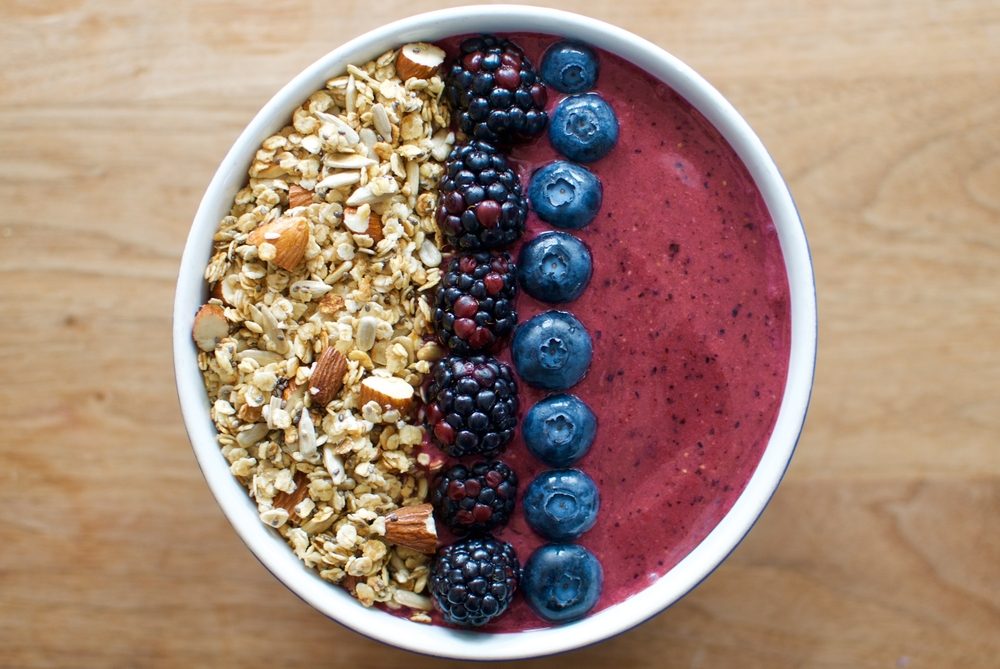 Smoothie bowl topped with berries and granola