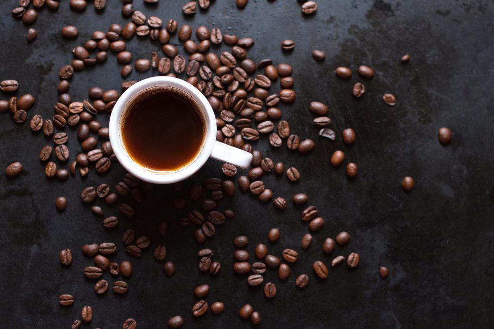 cup of coffee with coffee beans