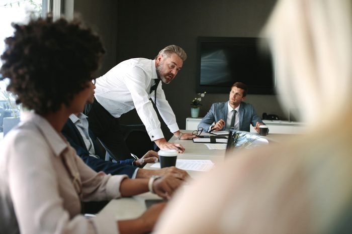 Senior executive explaining something to his team in a meeting. Business people during a meeting in board room.