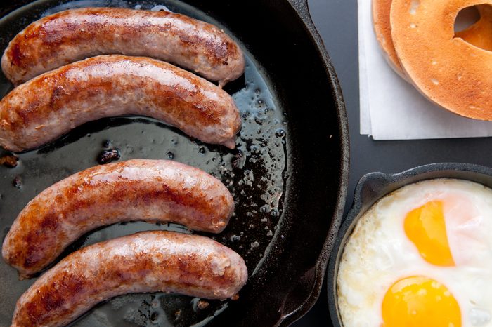 grilled sausage with eggs, bagel and hashbrowns breakfast