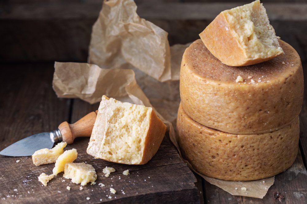 Parmesan and Pont-l'Eveque cheese cheeses on old wooden table