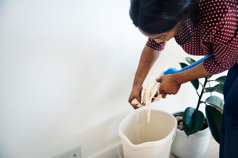 Black woman cleaning room