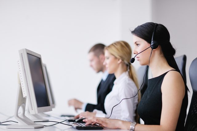 business people group with  headphones giving support in  help desk office to customers, manager giving training and education instructions