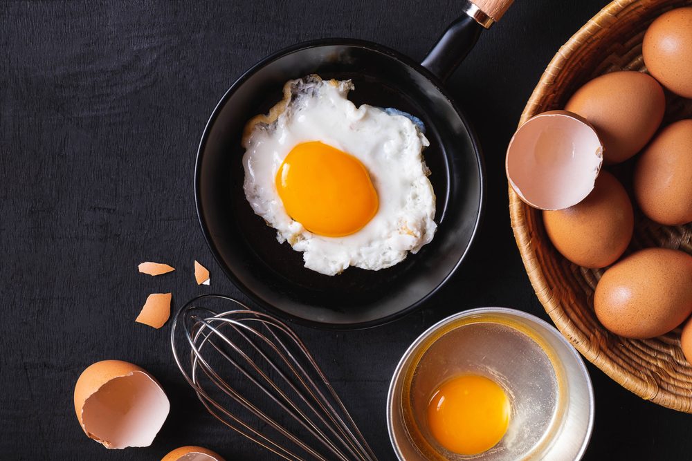 Frying pan in eggs and raw eggs