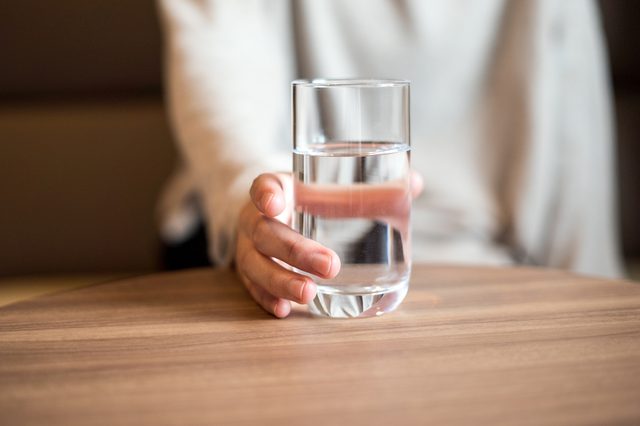 Woman holding a glass of the water