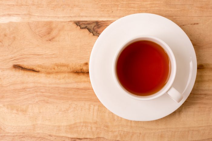 Cup of tea on a wooden tabletop.