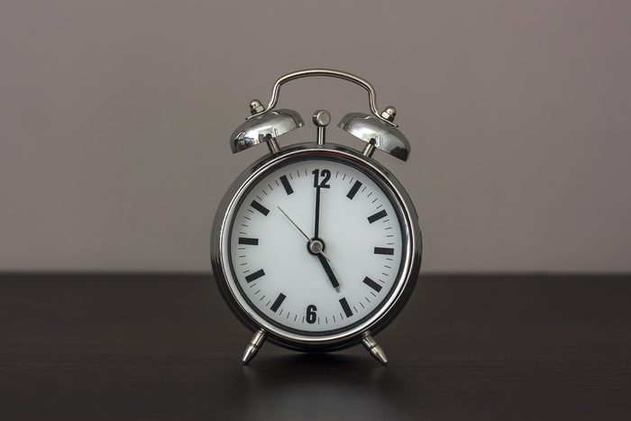 Alarm clock set at five.