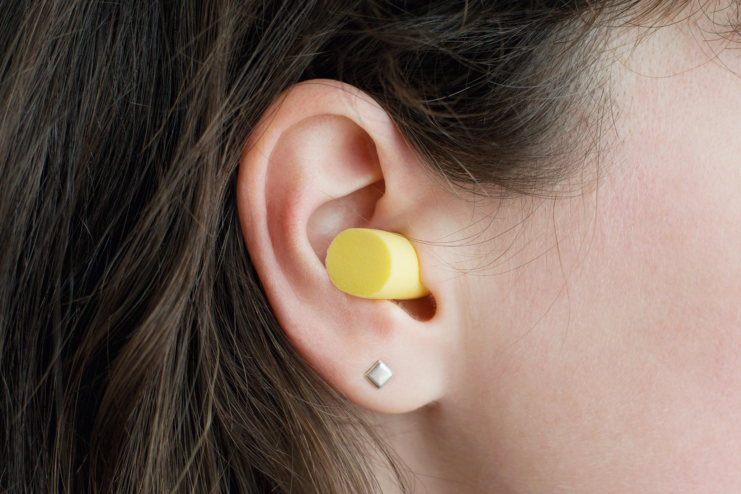 Women wearing an ear plug.