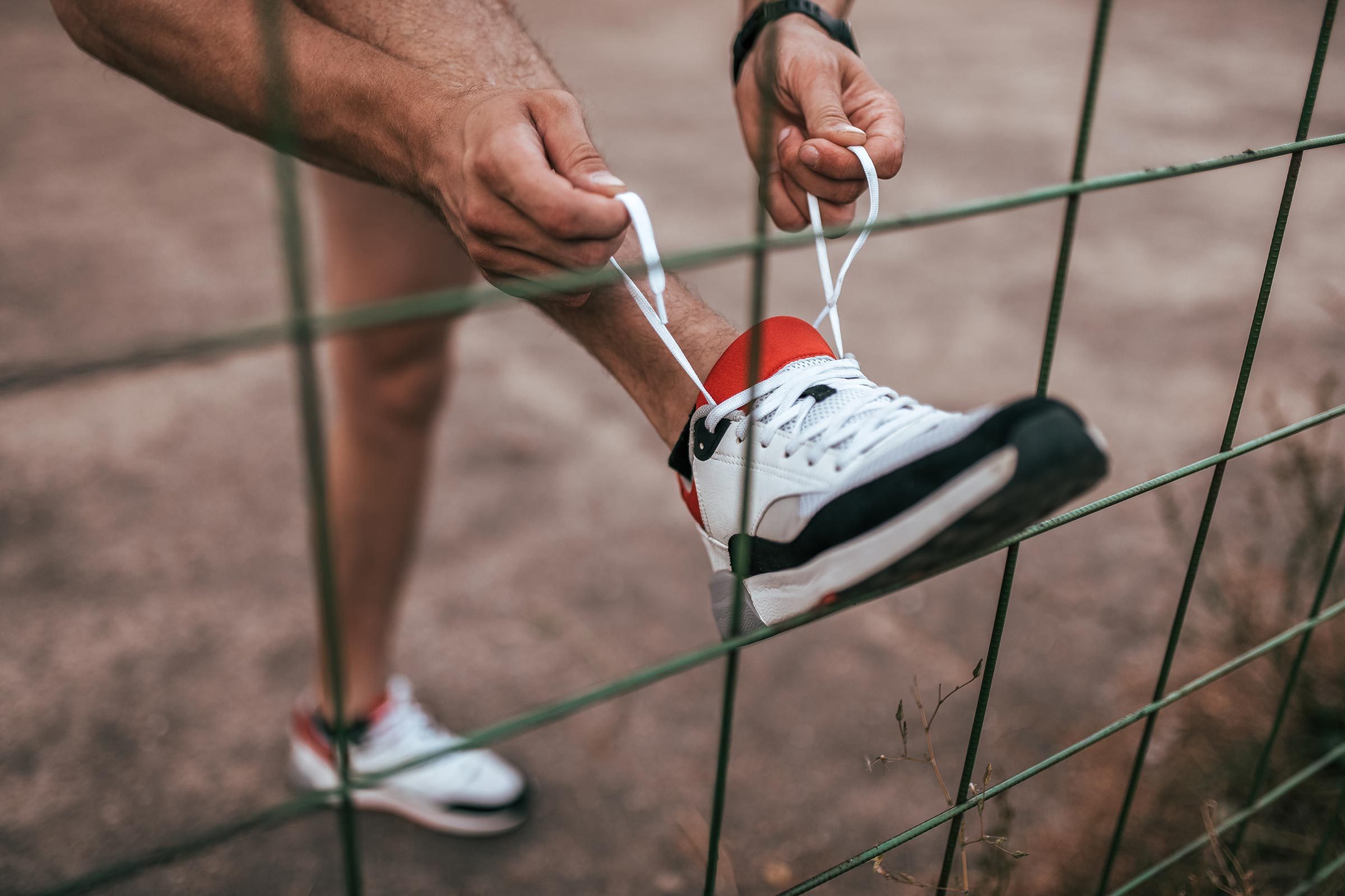 person tying their sneaker