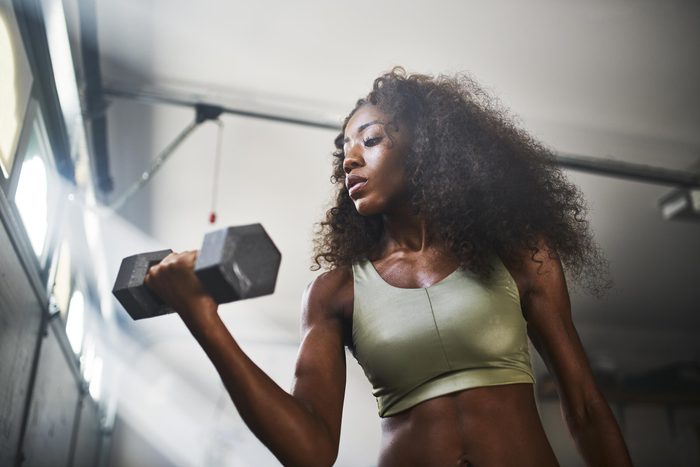 woman doing a bicep curl with weight