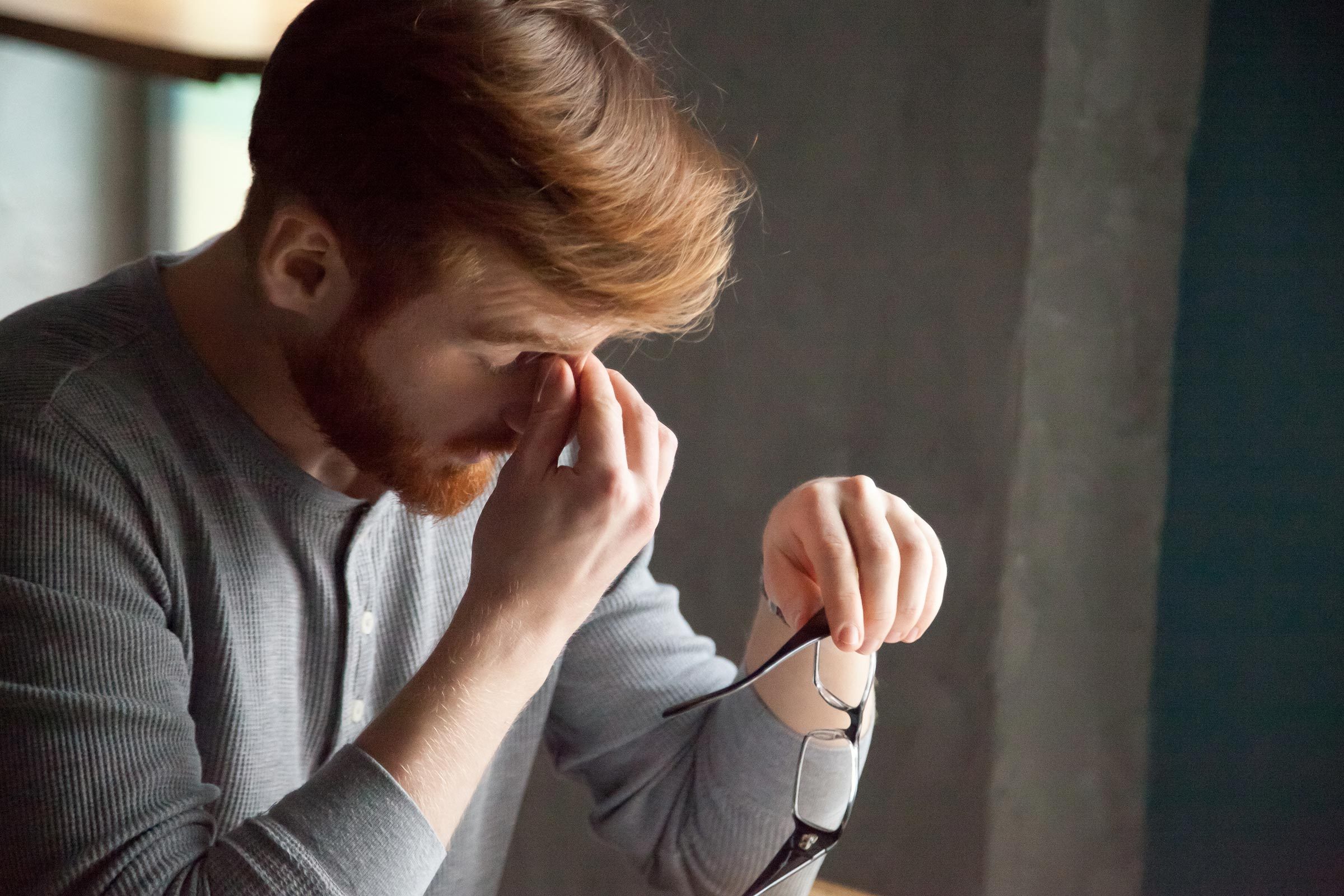 man tired rub eye