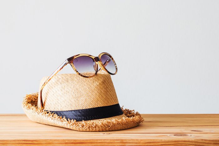 sunglasses on top of sun hat