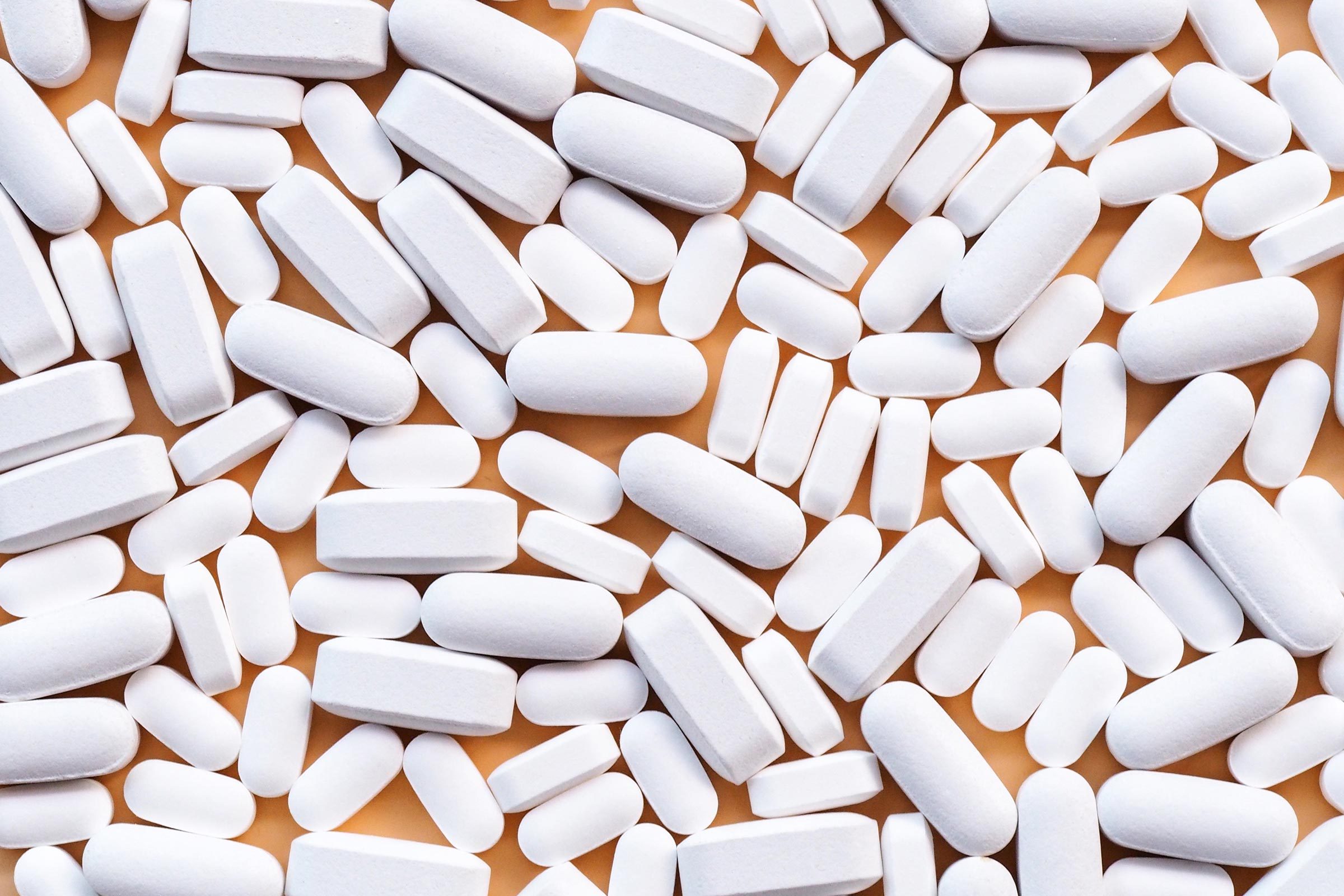 white pills on a yellow background