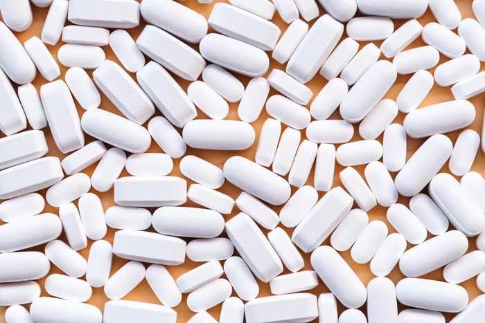 white pills on a yellow background