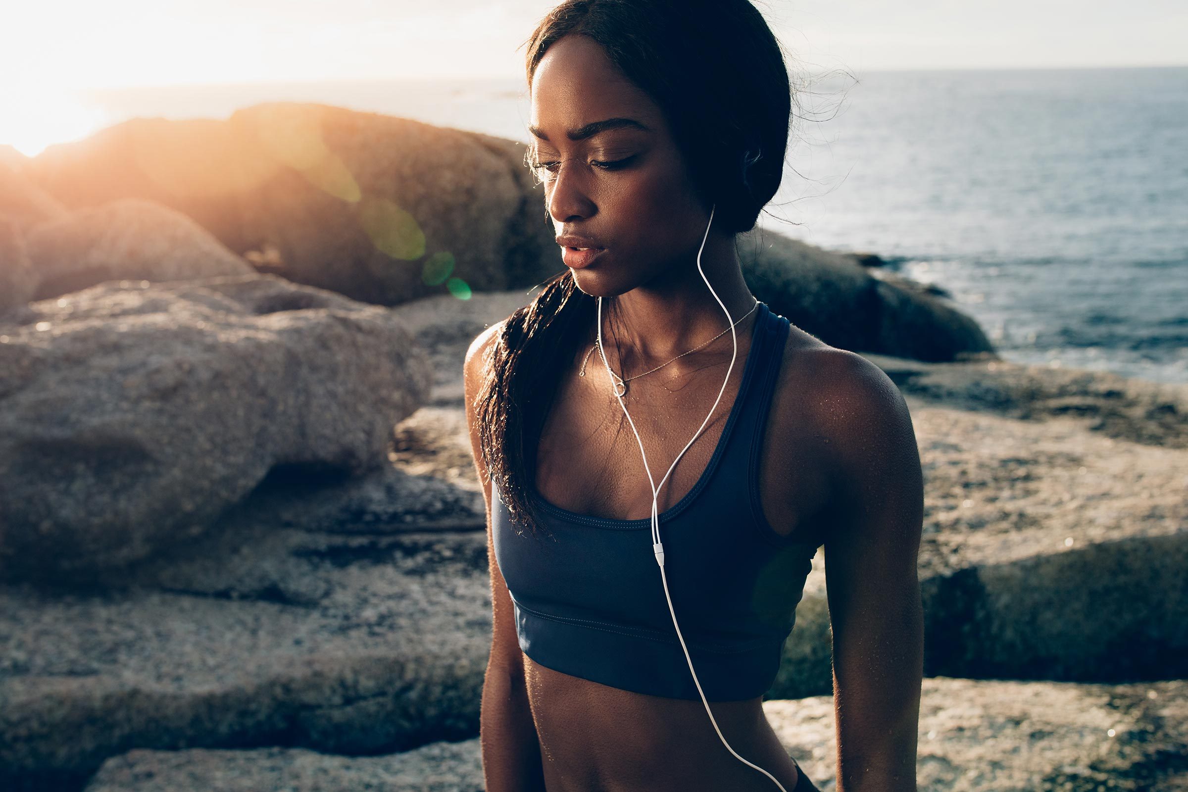 woman fitness sun flare ocean