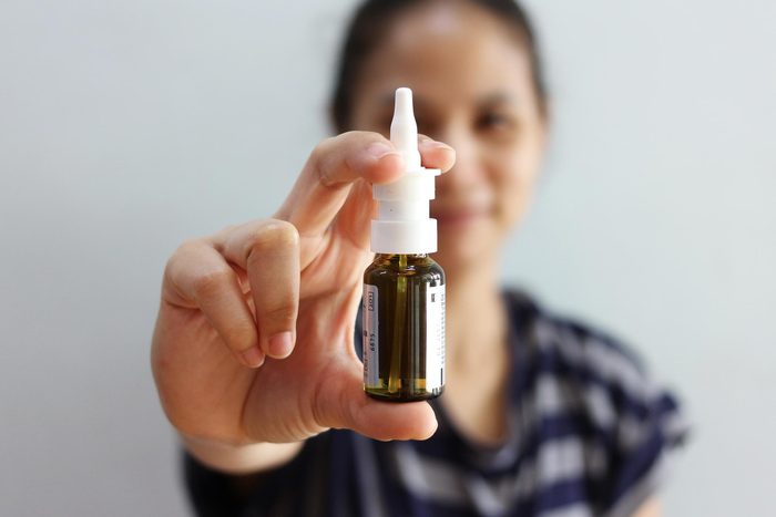 woman holding nasal spray